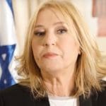 Former Israeli Foreign Minister, Tzipi Livni, with the flag of Israel behind her