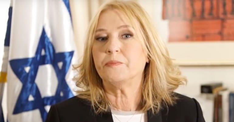 Former Israeli Foreign Minister, Tzipi Livni, with the flag of Israel behind her