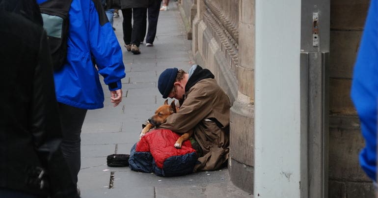 Homeless man on the street with his dog
