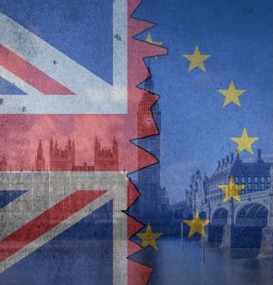 Union Jack and EU flags hiding parliament and Theresa May