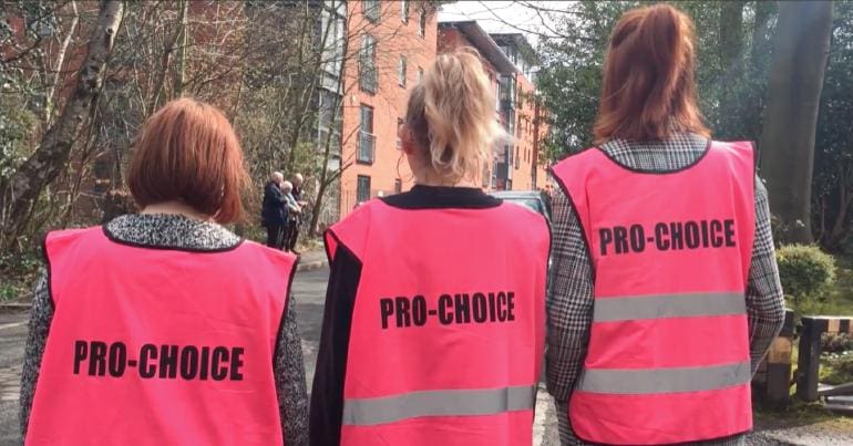 Women campaigners with jackets that say 'pro-choice' on them