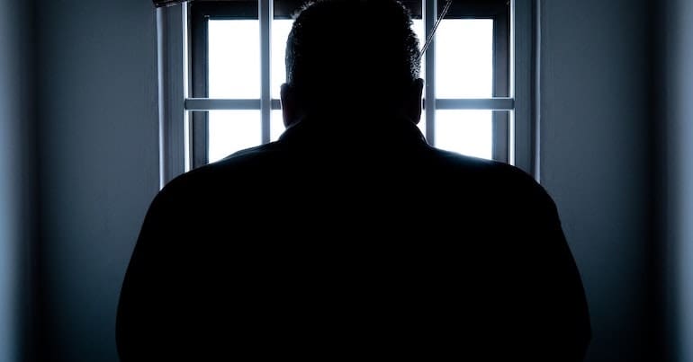 Person in jail from behind