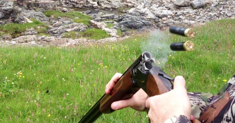 Cartridges being ejected from a shotgun