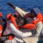 Refugee survivors in a dingy in the Mediteranean