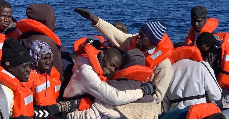 Refugee survivors in a dingy in the Mediteranean