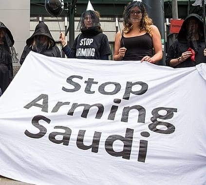 Protesters outside Department for Business with 'stop arming Saudi' banner