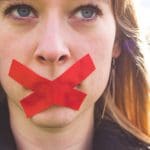 Woman with tape over mouth