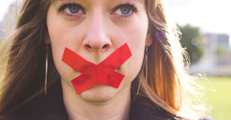 Woman with tape over mouth