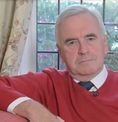 John McDonnell pictured next to someone relaxing in a hammock