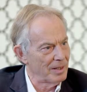 Tony Blair and Jeremy Corbyn standing in front of a crowd