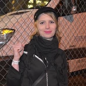 Chelsea Manning and a guard giving food to a prisoner in solitary confinement.