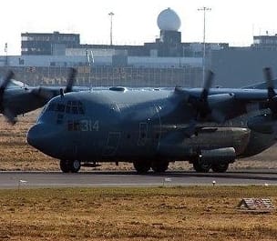 A picture of US soldiers in Shannon airport Ireland and a US military transport aircraft on the runway at Shannon airport