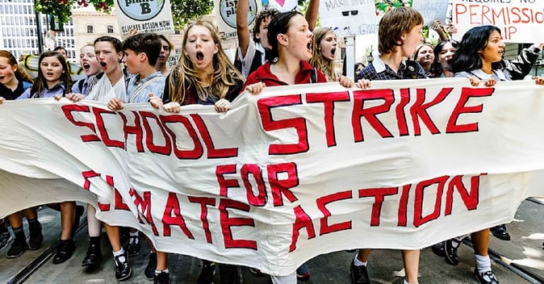 Kid with climate strike banner