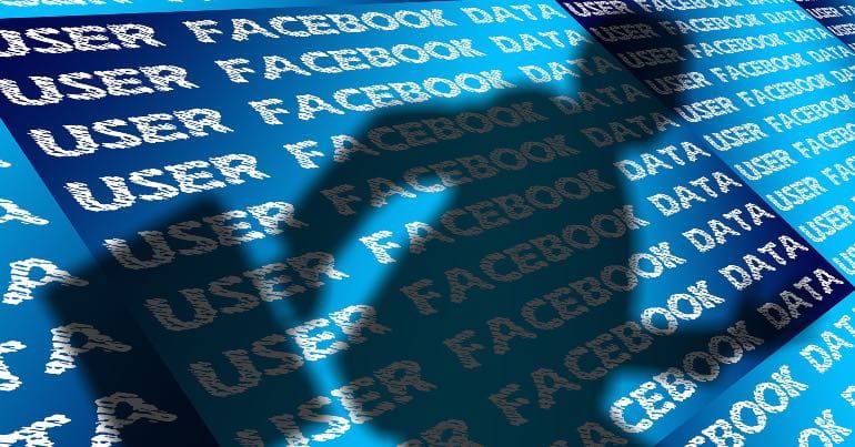 An image of shadowy figure running away with what is implied as Facebook users' data.