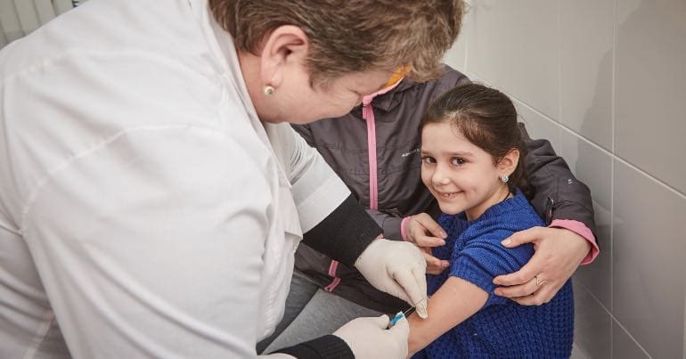 A picture of a Ukrainian girl getting a measles vaccination from a UNICEF clinic in Ukraine.