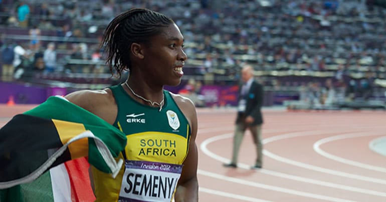 Caster Semenya wearing South Africa uniform and carrying flag
