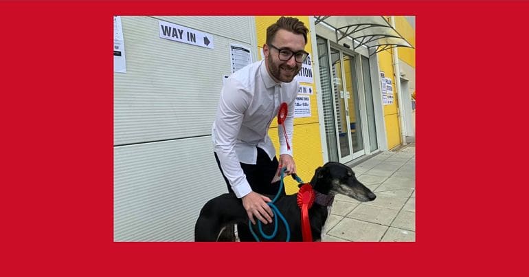 Writer Josh Funnell with a dog at a polling station