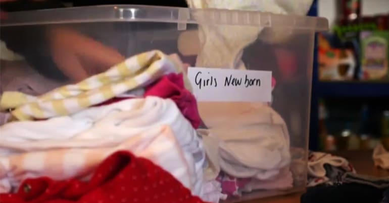 Storage box of clothes labelled 'Girls New Born'