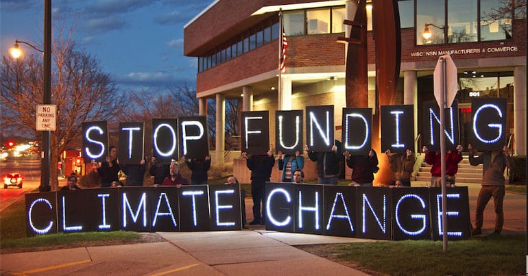 A banner that reads 'stop funding climate change\