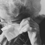 An elderly lady crying
