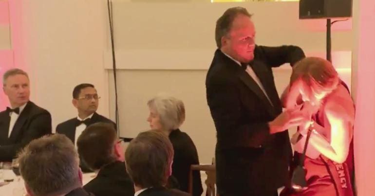 MP Mark Field pushing a woman against a pillar