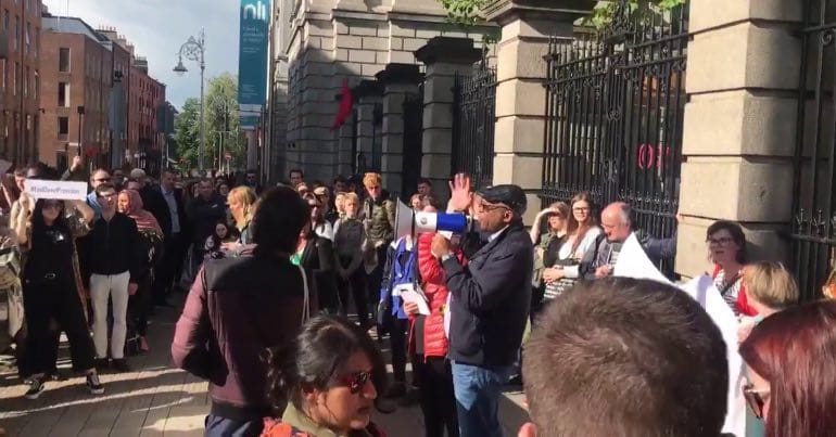 A photo of demonstrators outside Irish parliament on World Refugee Day.