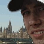 A confused looking man in front of the houses of Parliament