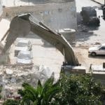 A bulldozer levelling a Palestinian home.
