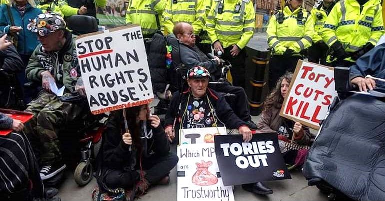 Police standing behind disability activists