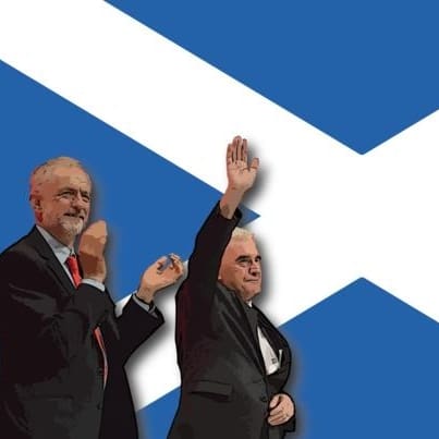Jeremy Corbyn and John McDonnell in front of the Saltire waving