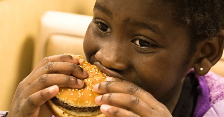 A child eating a burger