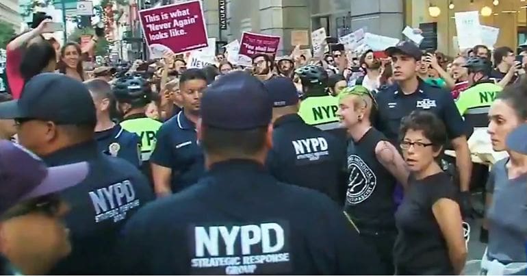 NYPD officers and Never Again Action protesters
