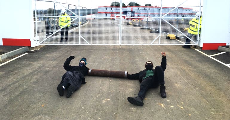Protesters locked on outside the entrance to HMP Wellingborough building site