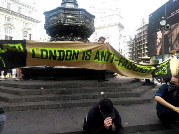 'London is anti-fascist' banner by Shaftesbury memorial fountain, Piccadilly Circus