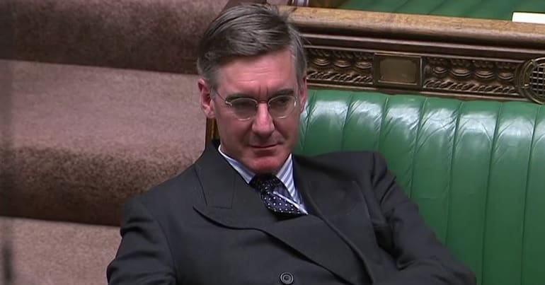 Jacob Rees-Mogg lounging in parliament