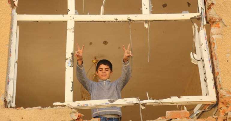 Boy in a bombed building in Farqin, Kurdistan
