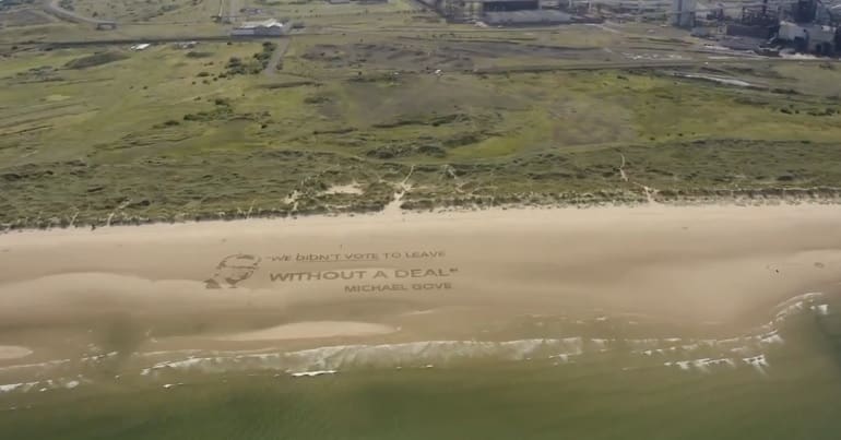 A quote from Michael Gove drawn on a beach which reads: We didn't vote to leave without a deal