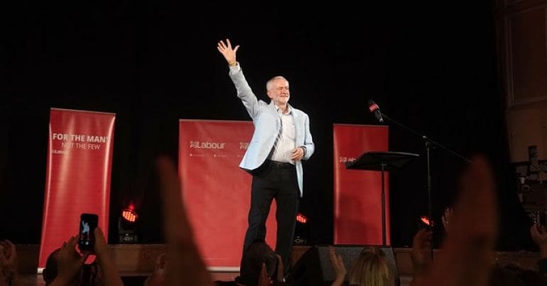 Jeremy Corbyn waving from the stage