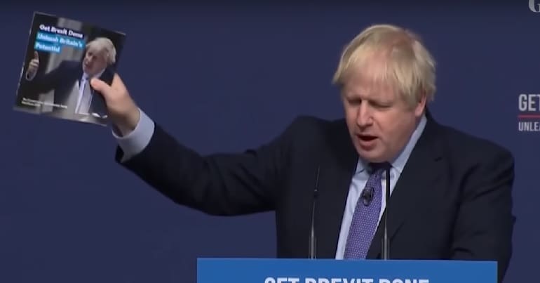 Boris Johnson speaking with manifesto in his hand at manifesto launch 2019