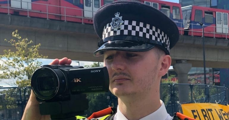 Cop filming protesters