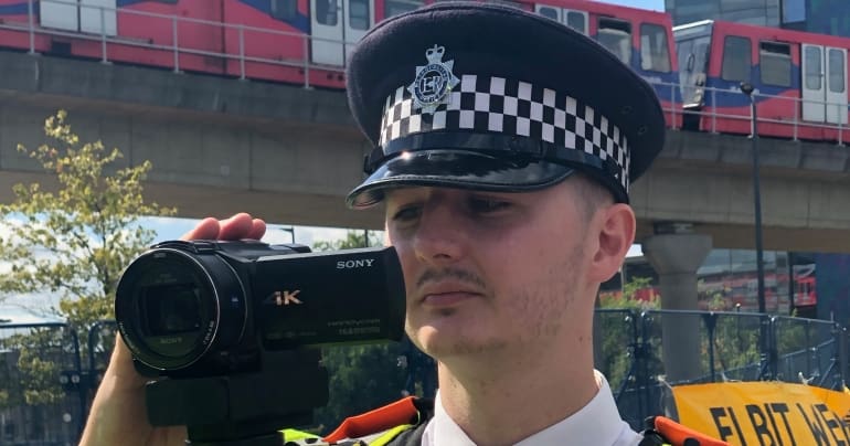 Cop filming protesters