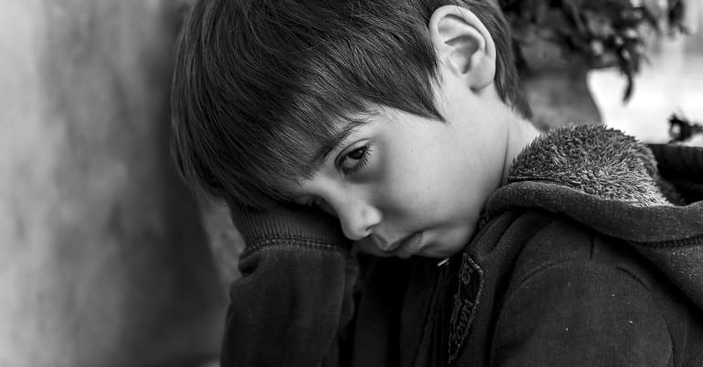 Child wearing a hoodie homelessness