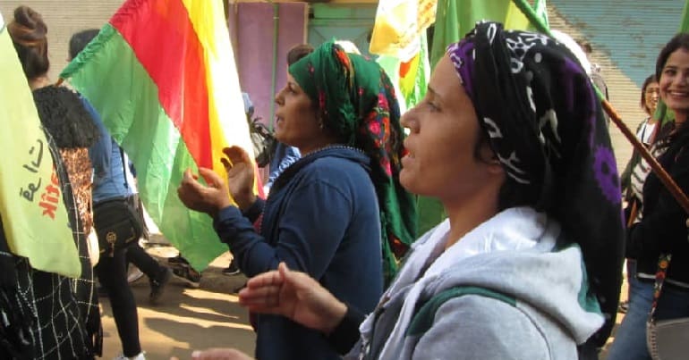 Women from Rojava's Jinwar village on a march