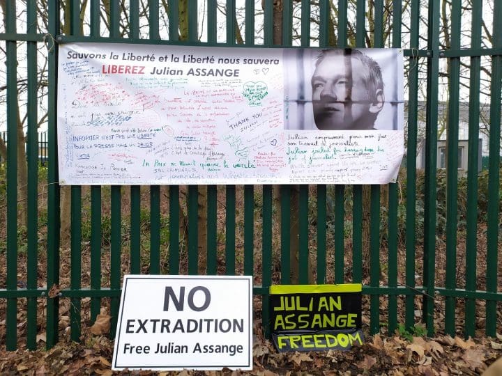 A collection of banners and posters calling for Julian Assanges Freedom on the fence bordering Belmarsh prison