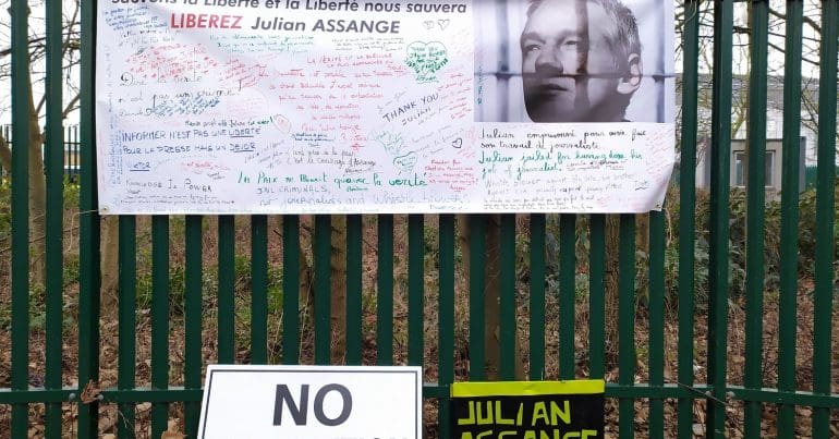 A collection of banners and posters calling for Julian Assanges Freedom on the fence bordering Belmarsh prison
