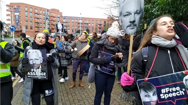 Crowd chants free Julian assange at the entrance of grounds to Belmarsh prison