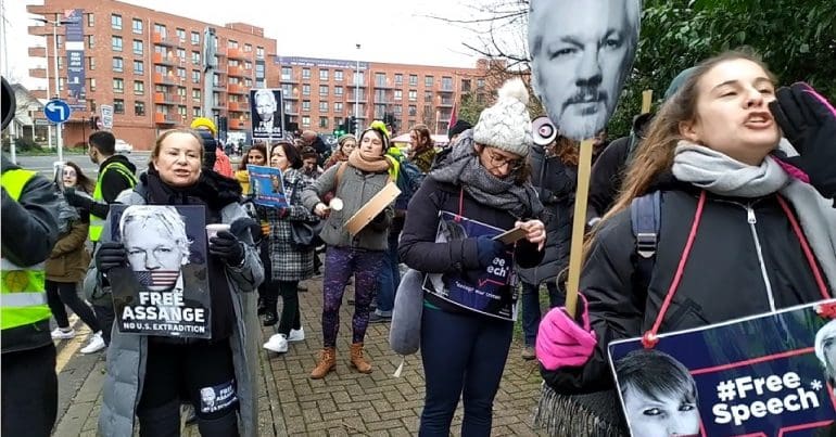 Crowd chants free Julian assange at the entrance of grounds to Belmarsh prison