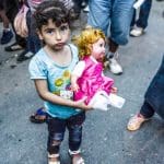 Syrian girl holding doll in a refugee camp in Serbia