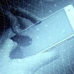 A hand holding a smart phone, using the internet