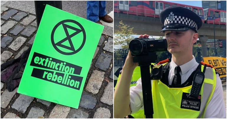 Extinction Rebellion protest sign and a police officer with camera